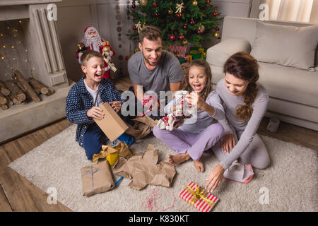 family opening presents on christmas eve Stock Photo