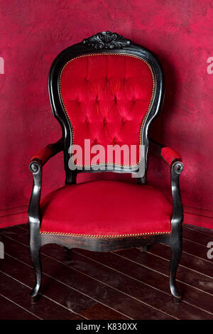 Classical style armchair. Antique wood sofa couch in vintage room. Stock Photo