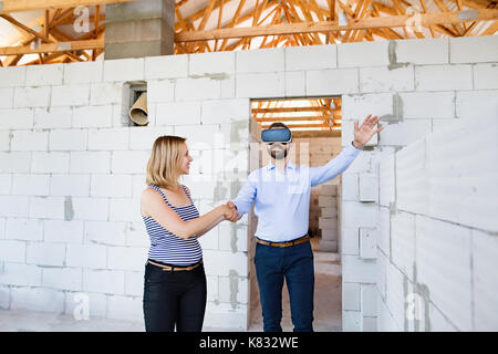Young married couple at the construction site. Stock Photo
