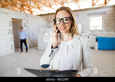 Architect at the construction site making a phone call. Stock Photo