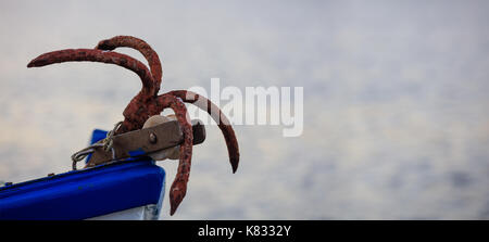 Fishing boat's rusty anchor close up Stock Photo