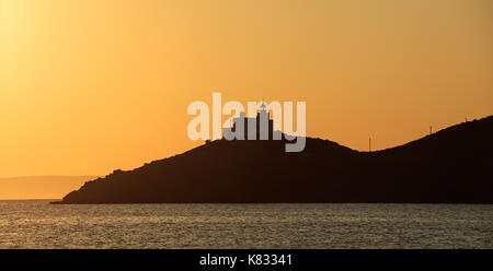 Greece, Kea island. Seascape with lighthouse at sunset Stock Photo