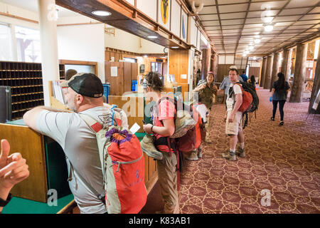 Guests checking in into the Swiftcurrent Lodge / hotel in Many Glacier National Park, Montana at the reception Stock Photo