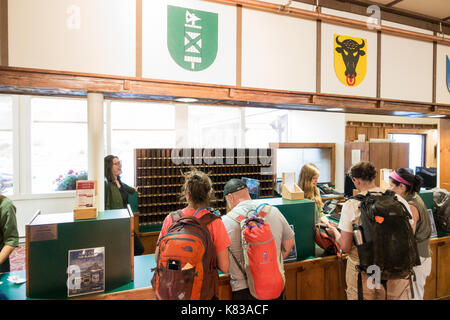 Guests checking in into the Swiftcurrent Lodge / hotel in Many Glacier National Park, Montana at the reception Stock Photo