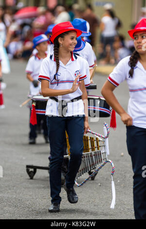 Tilaran, Costa Rica - September 15 : School children marching in the town square playing percussion instruments for the independence day parade. Septe Stock Photo