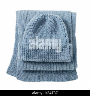 Knitted scarf and cap of blue color on isolated white background. Top view. Stock Photo