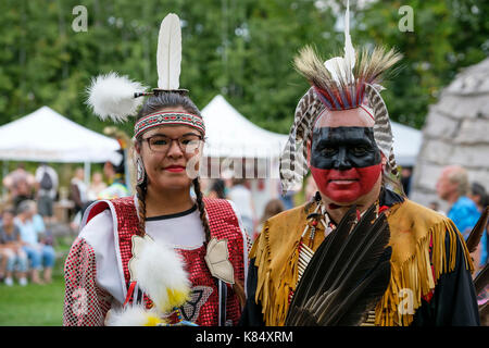 Canadian First Nations couple posing for a portrait wearing traditional regalia during a Pow Wow gathering in London, Ontario, Canada. Stock Photo