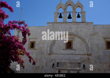 The Monastery of Panagia Tourliani in Mykonos, Greece.  People light candles for dead loved ones, interior and exterior views of the Monestary, bibles. Stock Photo