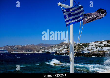 General views of Mykonos, Greece including buildings, flags and waterfront on September 56, 2017. Stock Photo