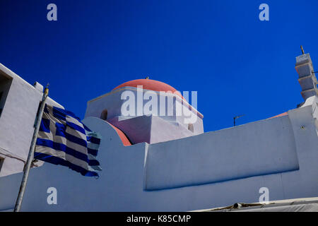 General views of Mykonos, Greece including buildings, flags and waterfront on September 56, 2017. Stock Photo