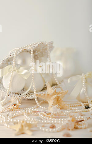 Christmas and New Year. Christmas-tree white toys in a marine style, seashells stones and starfish. Selective focus. Stock Photo