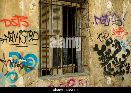 Building exteriors are covered with graffiti, wear and tear in Athens, Greece in 2017. Stock Photo