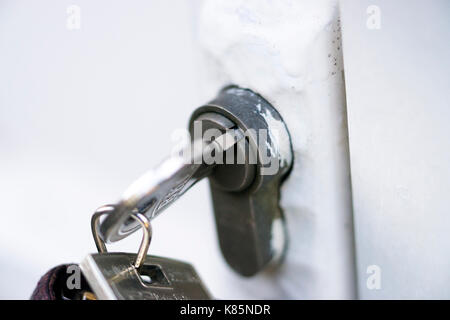 Door key in lock Stock Photo