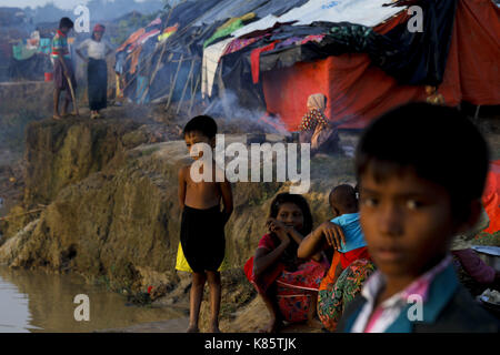September 17, 2017 - Septembar 17, 2017 Cox's Bazar, Bangladesh - Rohingya girl in front of their tent at the Thenkhali refugee camp in Cox's Bazar, Bangladesh. According to UNHCR more than 400 thousand Rohingya refugees have fled Myanmar from violence over the last few weeks, most trying to cross the border and reach Bangladesh. International organizations have reported claims of human rights violations and summary executions allegedly carried out by the Myanmar army. Credit: K M Asad/ZUMA Wire/Alamy Live News Stock Photo
