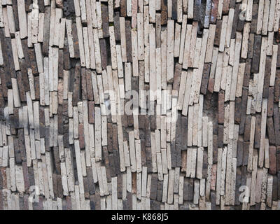 Vertically stacked stones, slates or bricks in shades of grey and tan, Aparan , a small town in Armenia, Stock Photo