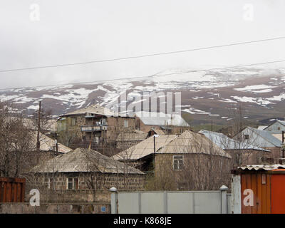 Aparan, small town in Armenia along the M3 highway, known by travellers for the Gntunik Bakery, here cluster of homes with mount Aragats in background Stock Photo