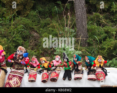 Home made locally crafted souvenir dolls in traditional Armenian costumes encountered on a roadside stall near Yerevan on an excursion Stock Photo