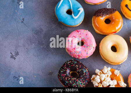 sweet doughnuts on gray stone background Stock Photo