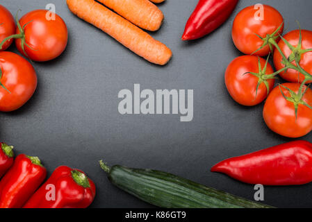 Directly above shot of fresh vegetables on blackboard Stock Photo