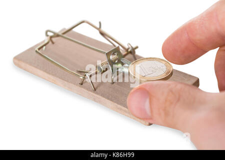 Cropped hand reaching coin on mousetrap against white background Stock Photo