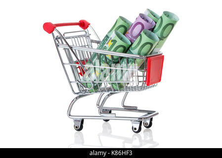 Rolled euro notes in shopping cart on table against white background Stock Photo