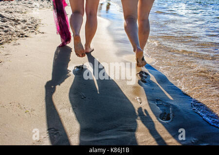 footprints in the wet sand of the beach on sunny summer day Stock Photo