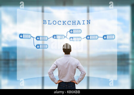 Person looking at blockchain concept on screen as a secured decentralized ledger for cryptocurrency financial technology and business transaction data Stock Photo