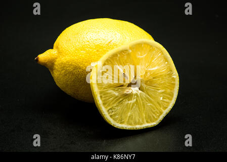 closeup of fresh limes and slice limes fruit isolated on black background Stock Photo
