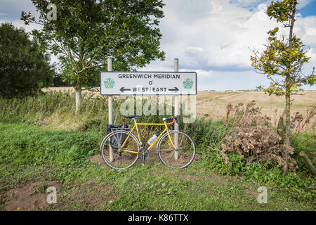 Cycling over the Greenwich meridian, Patrington, East Yorkshire, UK.