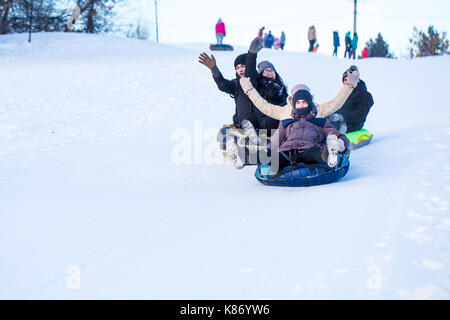 People slide down from the snow hill Stock Photo
