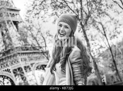 Autumn getaways in Paris. happy young woman near Eiffel tower having fun time Stock Photo