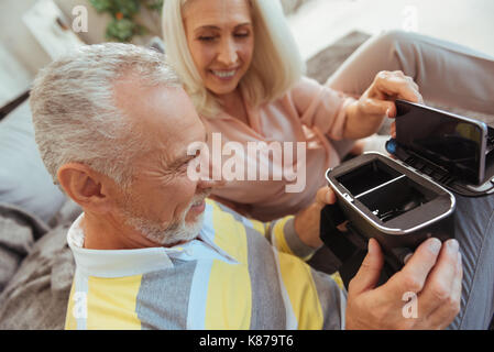 Cheerful aged couple using VR device Stock Photo
