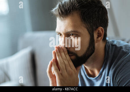 Cheerless handsome man feeling depressed Stock Photo