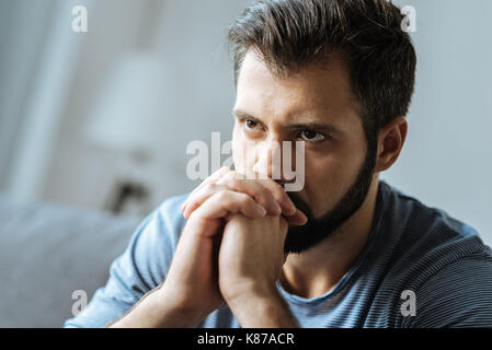 Cheerless thoughtful man feeling lonely Stock Photo