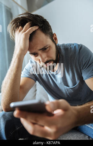 Depressed bearded man feeling unhappy Stock Photo