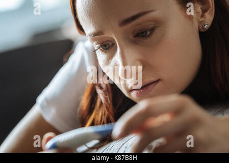 Upset young woman feeling ill Stock Photo