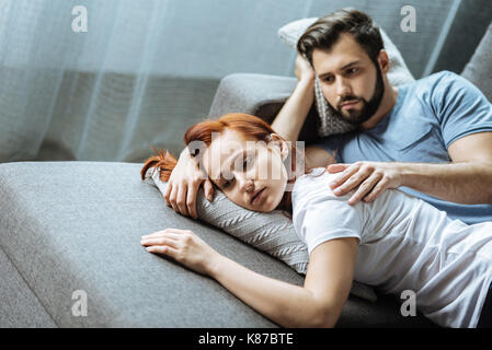 Handsome nice man holding his girlfriends shoulder Stock Photo