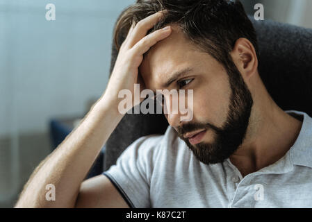 Sad bearded man feeling frustrated Stock Photo