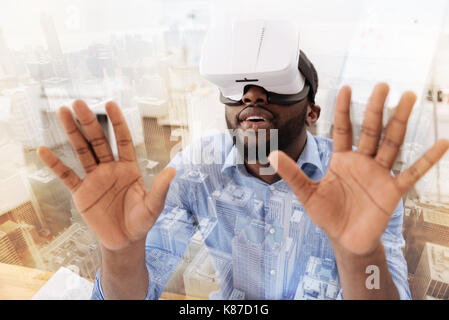 Relaxed man using virtual mask Stock Photo