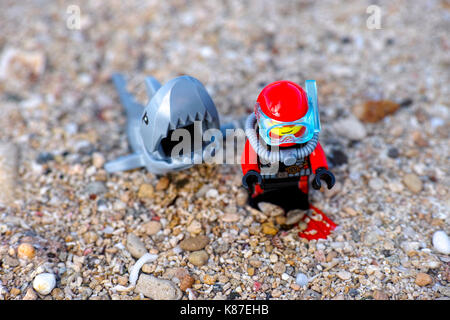 Paphos, Cyprus - October 09, 2016 Lego shark preparing to attack scuba diver in the sea. Top view. Stock Photo