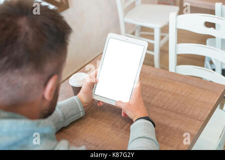 Tablet with isolated screen in man hand. Blank screen for mockup. Stock Photo