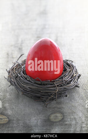 Red Easter egg in the nest Stock Photo