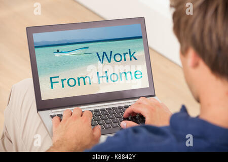 Close-up Of Young Man Working On Laptop At Home Stock Photo