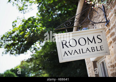 Exterior view of building with sign advertising available rooms. Stock Photo