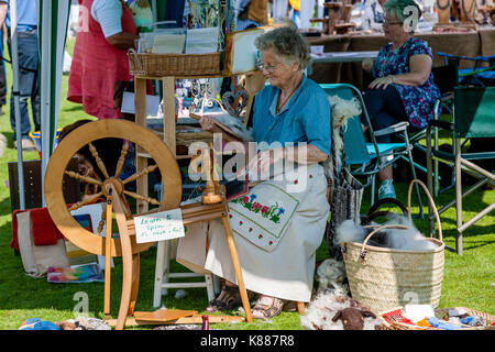 An Elderly Woman Spinning Wool, Hartfield Village Fete, Hartfield, Sussex, UK Stock Photo