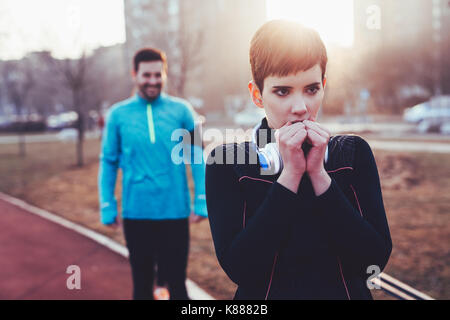 Woman fitness exercising in cold weather outdoor Stock Photo