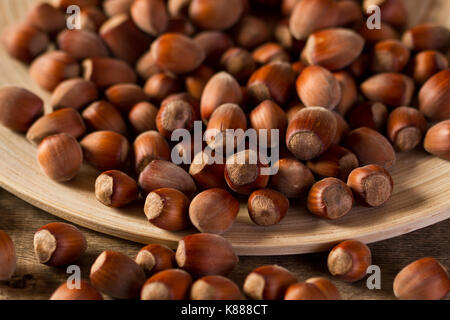 Hazelnuts on wooden plate Stock Photo