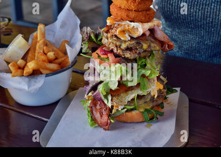 Very big unhealthy Australian hamburger with chips Stock Photo