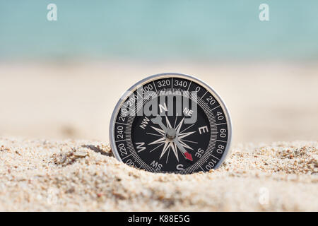 Close-up Photo Of Black Compass On Sand Stock Photo