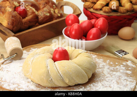 Easter sweet bread dough with red eggs Stock Photo